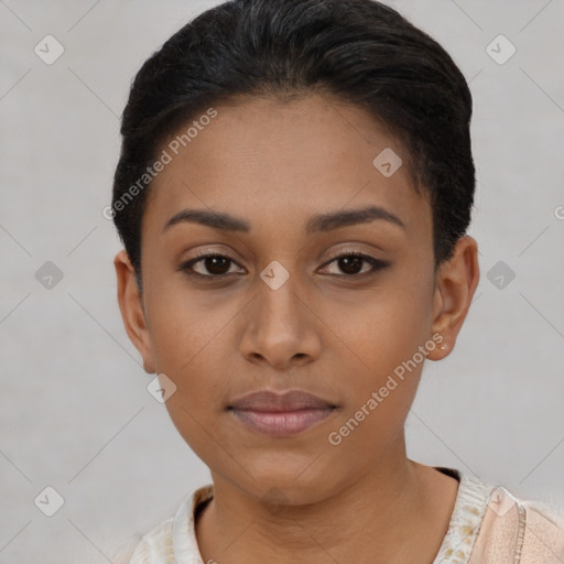 Joyful black young-adult female with short  black hair and brown eyes