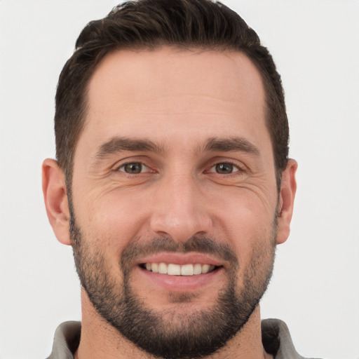 Joyful white young-adult male with short  brown hair and brown eyes