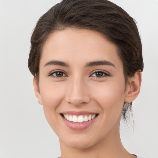 Joyful white young-adult female with short  brown hair and brown eyes