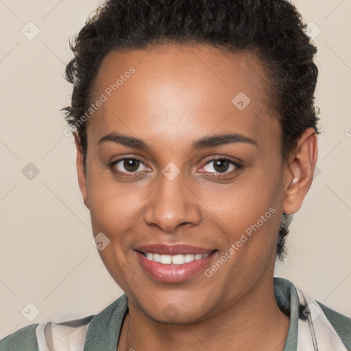 Joyful black young-adult female with short  brown hair and brown eyes