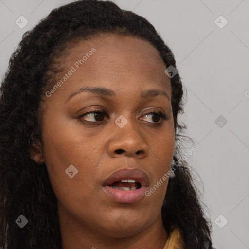 Joyful black young-adult female with long  brown hair and brown eyes