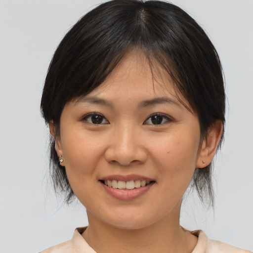 Joyful asian young-adult female with medium  brown hair and brown eyes