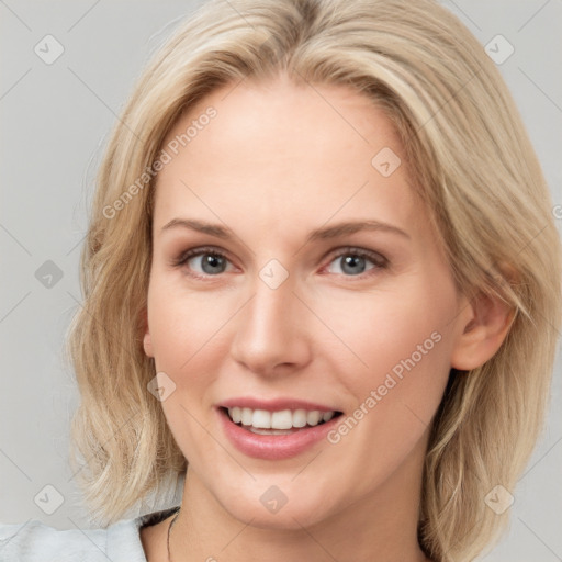 Joyful white young-adult female with medium  brown hair and blue eyes