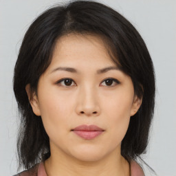 Neutral asian young-adult female with medium  brown hair and brown eyes