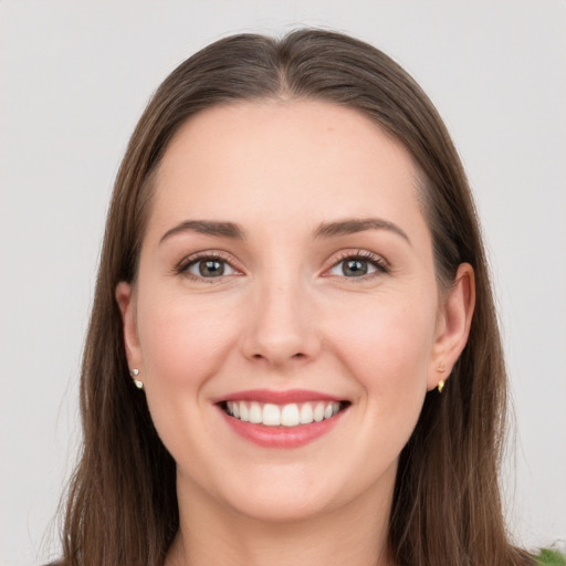 Joyful white young-adult female with long  brown hair and grey eyes