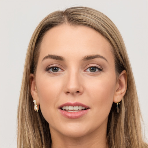 Joyful white young-adult female with long  brown hair and brown eyes