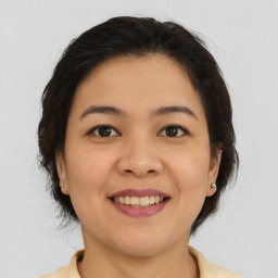 Joyful asian young-adult female with medium  brown hair and brown eyes