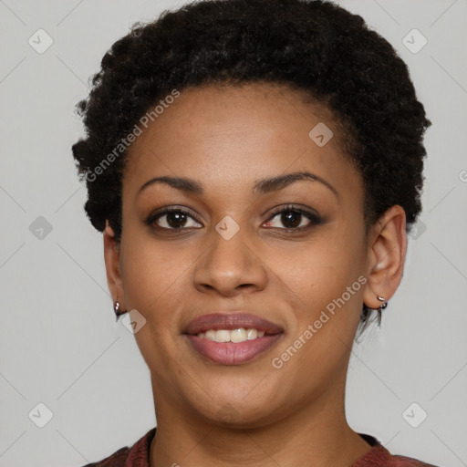 Joyful black young-adult female with short  brown hair and brown eyes