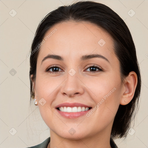 Joyful white young-adult female with medium  brown hair and brown eyes