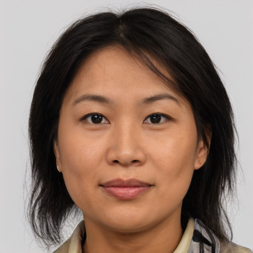 Joyful asian young-adult female with medium  brown hair and brown eyes