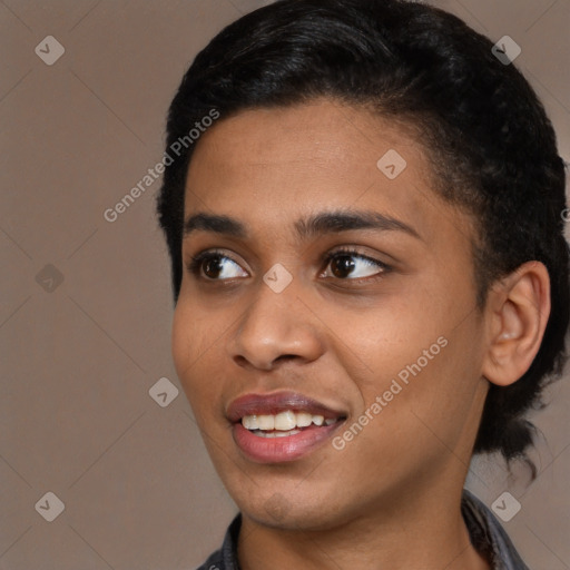 Joyful black young-adult female with short  black hair and brown eyes