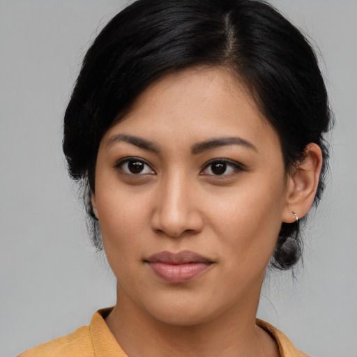 Joyful latino young-adult female with medium  black hair and brown eyes