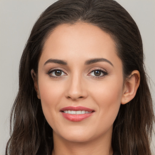 Joyful white young-adult female with long  brown hair and brown eyes