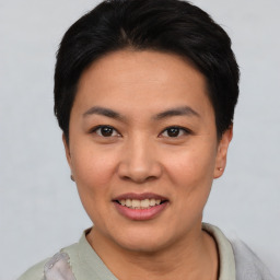 Joyful asian young-adult female with short  black hair and brown eyes