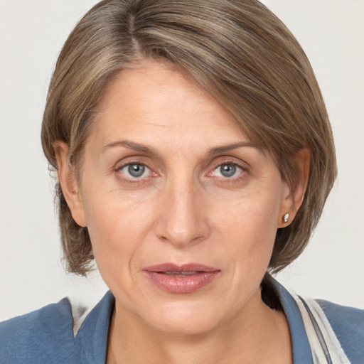 Joyful white adult female with medium  brown hair and grey eyes