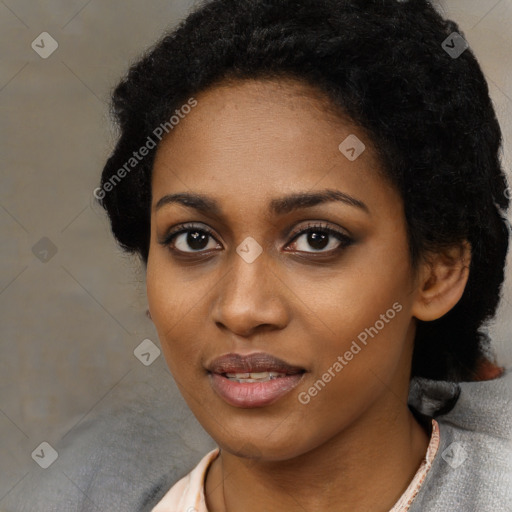 Joyful black young-adult female with short  black hair and brown eyes