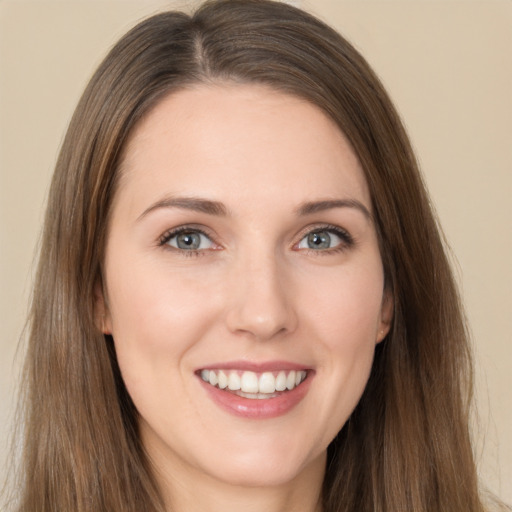 Joyful white young-adult female with long  brown hair and brown eyes