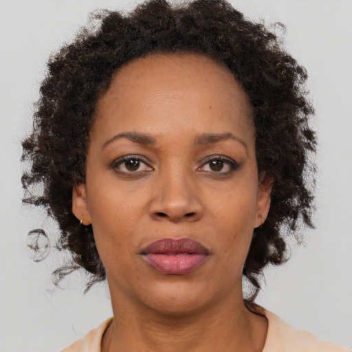 Neutral black adult female with medium  brown hair and brown eyes