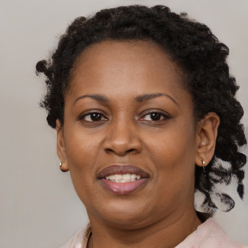 Joyful black adult female with short  brown hair and brown eyes