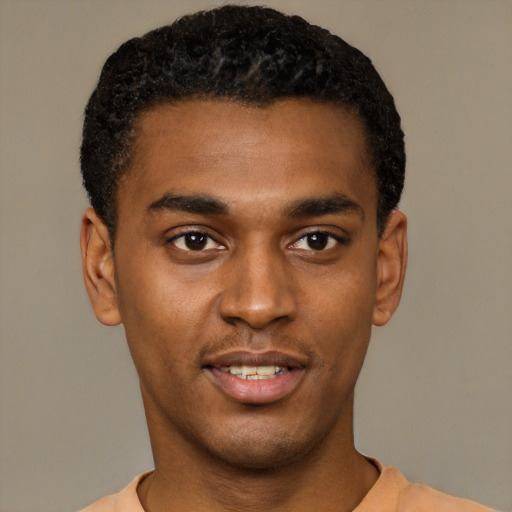 Joyful black young-adult male with short  black hair and brown eyes