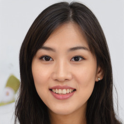 Joyful asian young-adult female with long  brown hair and brown eyes