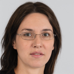 Joyful white adult female with long  brown hair and brown eyes