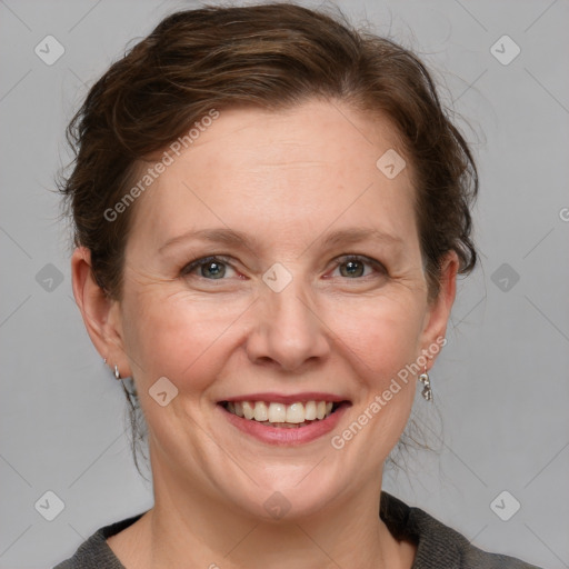 Joyful white adult female with medium  brown hair and blue eyes