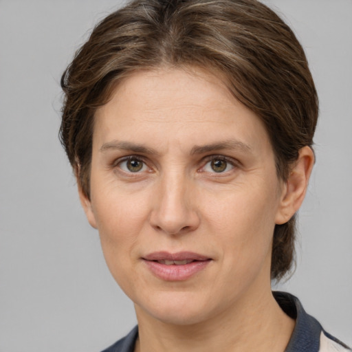 Joyful white adult female with medium  brown hair and grey eyes