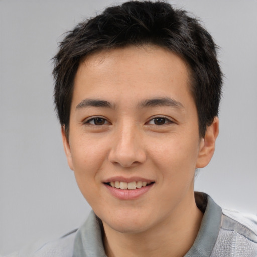Joyful asian young-adult male with short  brown hair and brown eyes