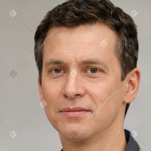 Joyful white adult male with short  brown hair and brown eyes