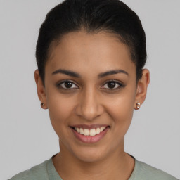 Joyful latino young-adult female with short  brown hair and brown eyes