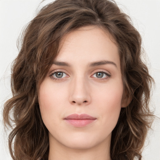 Joyful white young-adult female with long  brown hair and green eyes