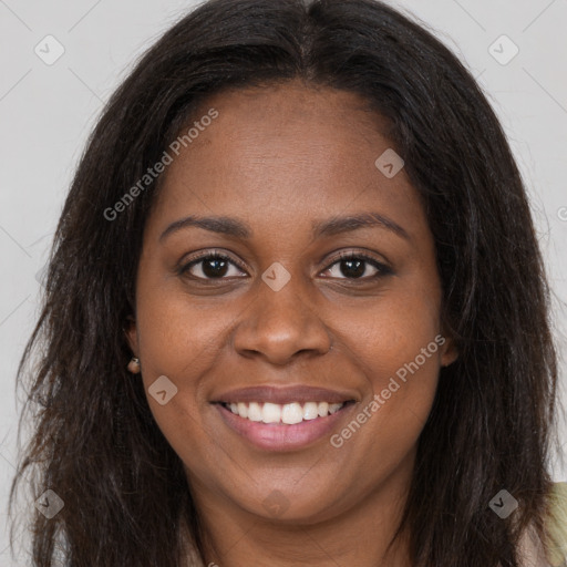 Joyful black young-adult female with long  brown hair and brown eyes