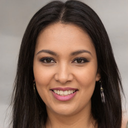 Joyful latino young-adult female with long  brown hair and brown eyes