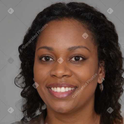 Joyful black young-adult female with long  brown hair and brown eyes