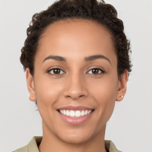 Joyful white young-adult female with short  brown hair and brown eyes