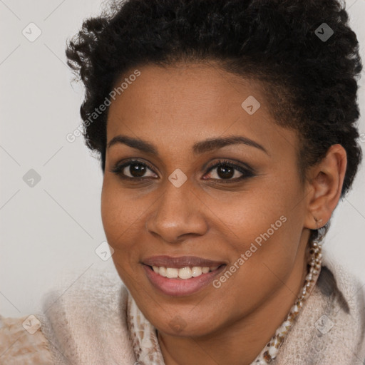 Joyful black young-adult female with short  brown hair and brown eyes