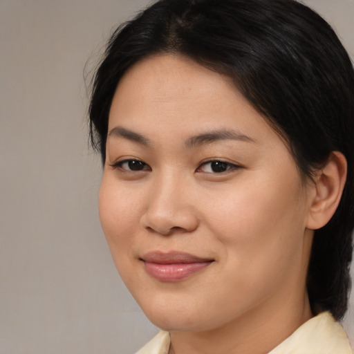 Joyful asian young-adult female with medium  brown hair and brown eyes