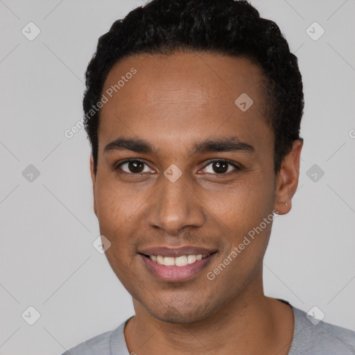 Joyful black young-adult male with short  black hair and brown eyes