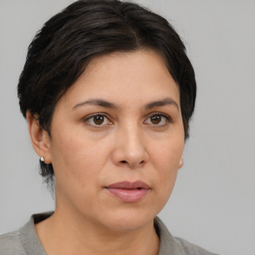 Joyful white adult female with medium  brown hair and brown eyes