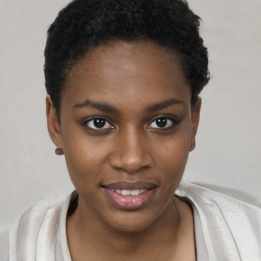 Joyful black young-adult female with short  black hair and brown eyes