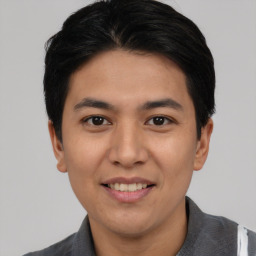 Joyful asian young-adult male with short  black hair and brown eyes