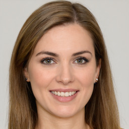 Joyful white young-adult female with long  brown hair and green eyes