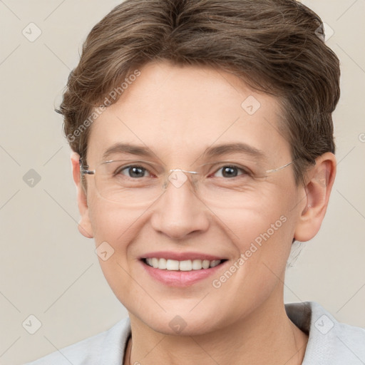 Joyful white adult female with short  brown hair and grey eyes