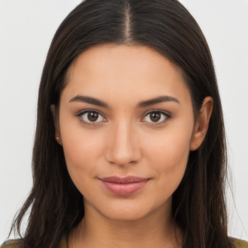 Joyful latino young-adult female with long  brown hair and brown eyes