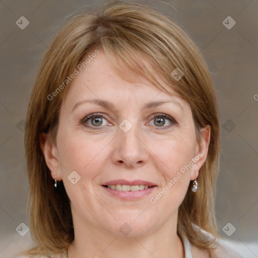 Joyful white adult female with medium  brown hair and grey eyes