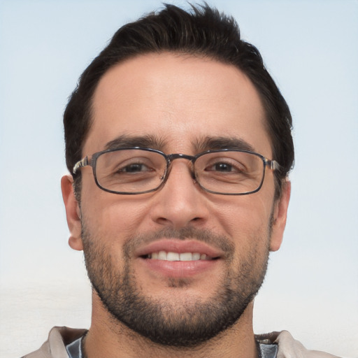 Joyful white adult male with short  brown hair and brown eyes