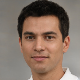 Joyful white young-adult male with short  black hair and brown eyes