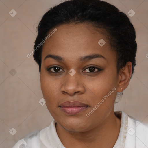 Joyful black young-adult female with short  black hair and brown eyes