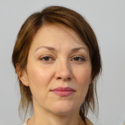 Joyful white adult female with medium  brown hair and brown eyes